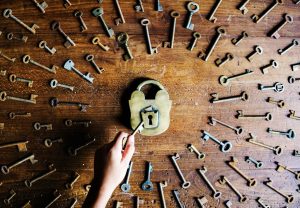 we see an antique lock with one key about to go in correctly while other keys side aside and do not fit. this is a visual metaphor for understanding progesterone side effects.