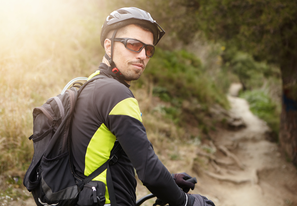 a mountain biker is looking over his shoulder at us while preparing to tackle the next leg of his trail run. He is all about balance and power which is why bhrt for men is perfect for him.